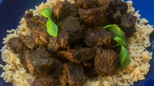Tender chunks of beef simmered in rich Rendang curry sauce, seasoned with Shawhan Farms spices and garnished with fresh herbs—served over rice. Photo credit to My Curated Tastes