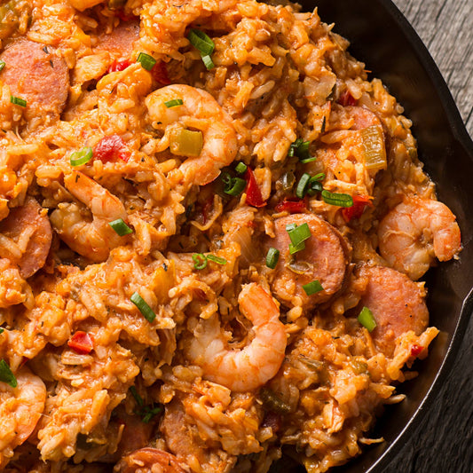 A close up of a cast iron skillet filled with jambalaya.