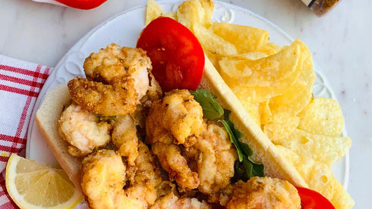 fried shrimp on bread on a white plate with potato chips