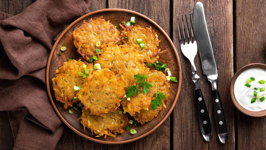 crispy potato latkes on plate with green onion topping