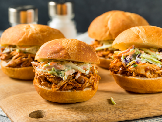 BBQ chicken on a golden brown bun with coleslaw