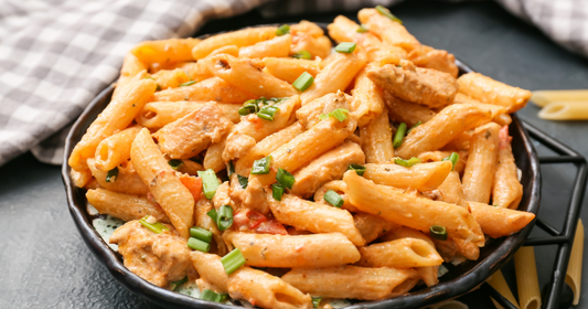 Creamy penne pasta with chicken, green onion, and sundried tomato