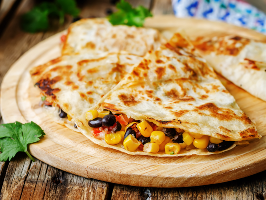 corn, black bean, cheese and tomato in a quesadilla