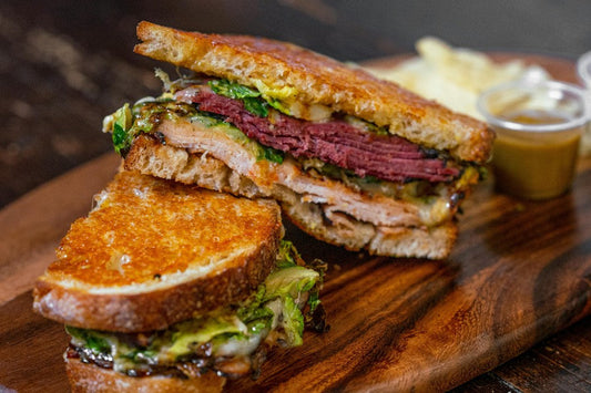 Sandwich sliced in two on a cutting board