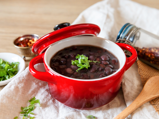 Black Beans in a small cocotte with some herbs and seasonings