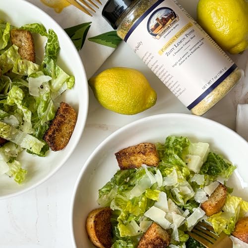 Two bowls of green salad with croutons, whole lemons on the side with a bottle of Shawhan Farms Zesty Lemon Pepper Seasoning. 